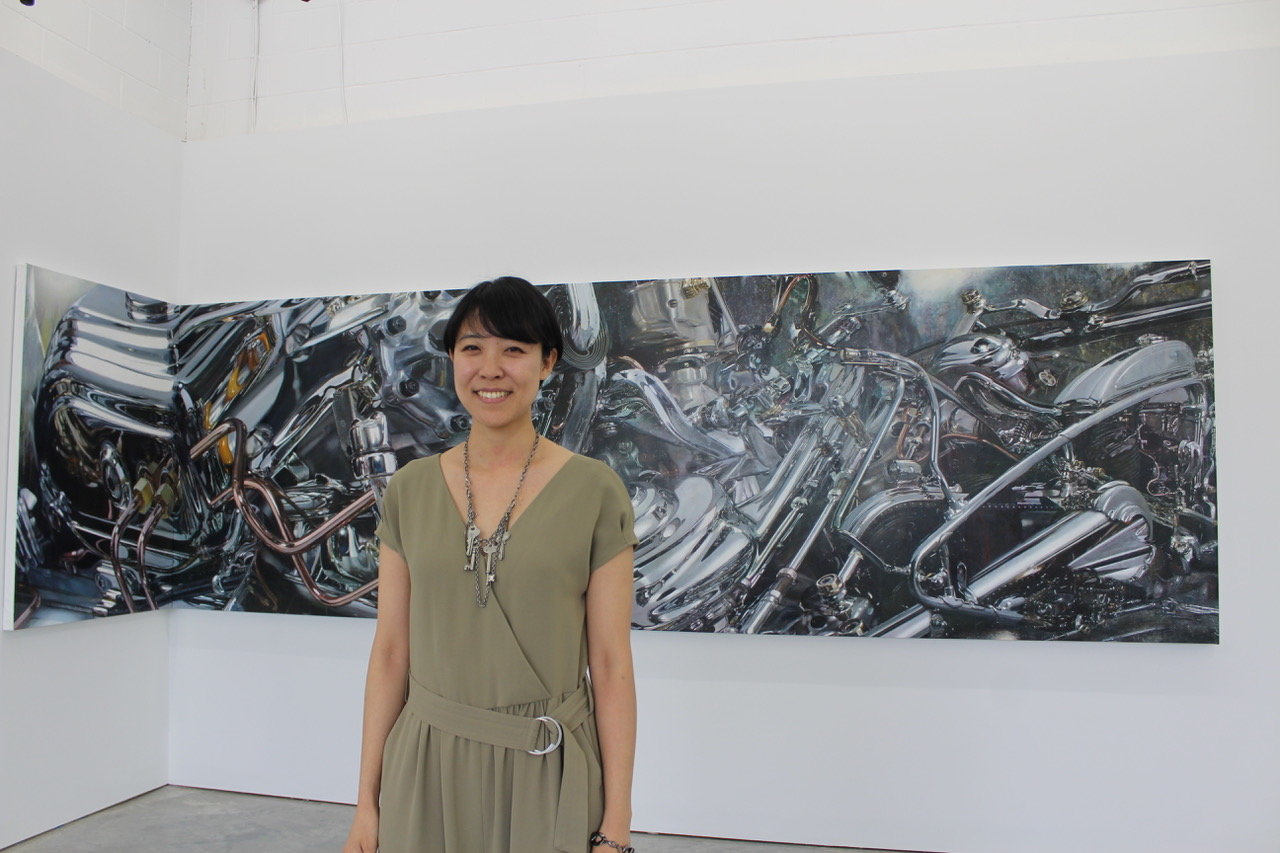 Japanese artist Ai Makita stands in front of one of her works in the “Tectonic Shifts” exhibit at The Something Machine gallery in Bellport.